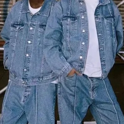 Two people in matching light-wash denim jackets and jeans, shown from the shoulders to the hips