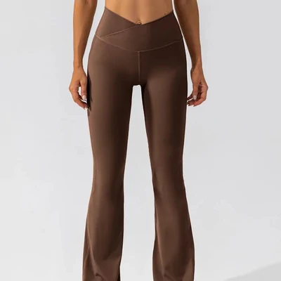 Brown crossover-waist flared leggings worn by a model, shown from the waist to the calf